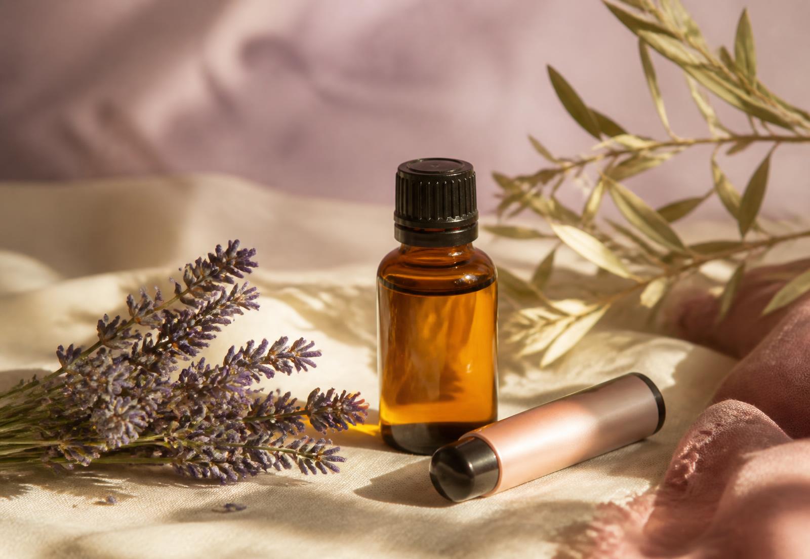 Essential oil bottles and dried lavender arranged in soft morning light